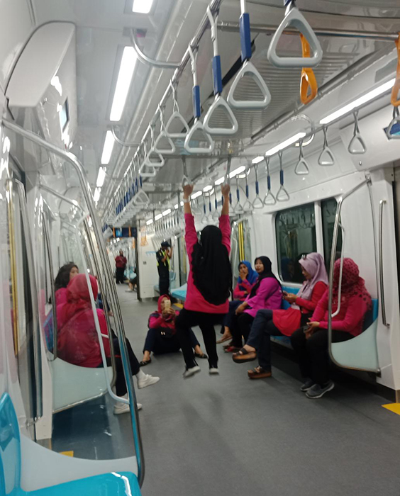 ぶら下がる、駅の床で食事　さっそくマナー違反　ＭＲＴジャカルタ  